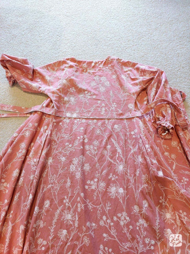 Sewing on the ribbon for a DIY wrap dress