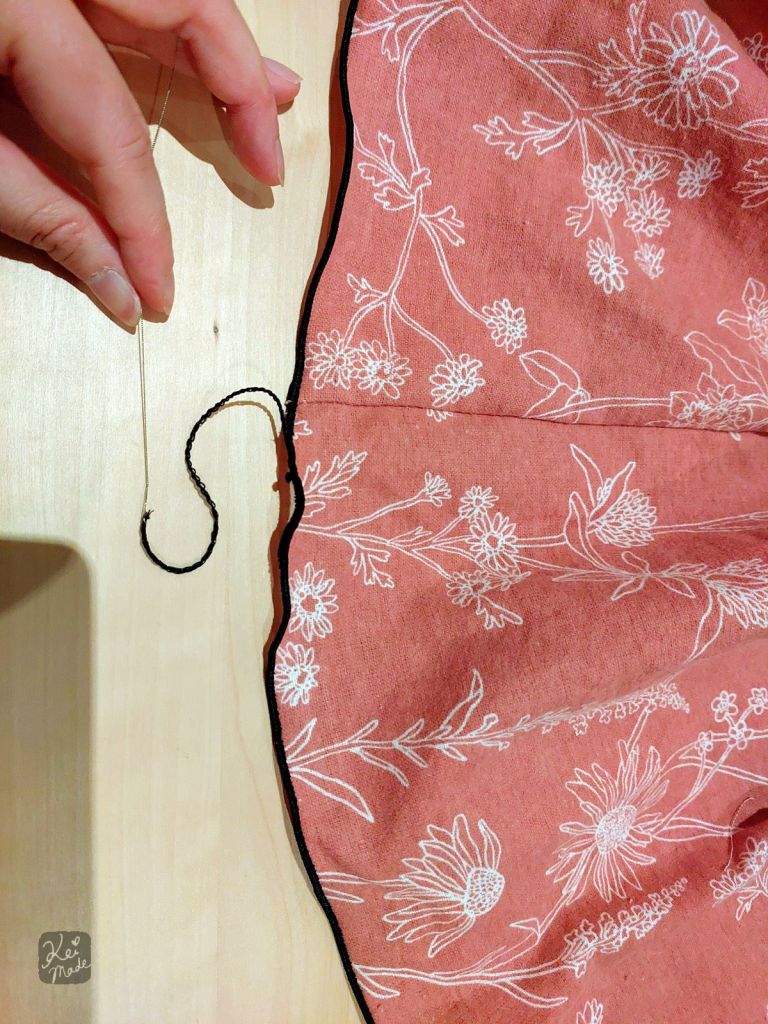 Pulling the rolled hem end in secure using a looper threader wire